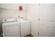 Laundry room featuring a washer, dryer, wire shelving, and a white door at 3168 Lodgepole Dr, Whiteland, IN 46184