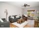 Inviting living room with a comfortable gray sofa, wood-look floors, and natural light at 3168 Lodgepole Dr, Whiteland, IN 46184