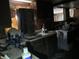 Dated kitchen with dark cabinetry, worn countertops, and miscellaneous items scattered about at 326 N Grant St, Brownsburg, IN 46112