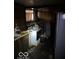 Outdated kitchen with worn cabinets, appliances, and clutter throughout the room at 326 N Grant St, Brownsburg, IN 46112