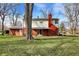 Back of house with brick exterior, covered patio, and a large backyard at 333 E Waterbury Rd, Indianapolis, IN 46227
