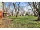 Large backyard featuring mature trees, green grass, and other homes at 333 E Waterbury Rd, Indianapolis, IN 46227