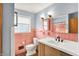 Charming bathroom with pink tile, modern vanity, and updated fixtures that combine vintage charm with modern style at 333 E Waterbury Rd, Indianapolis, IN 46227