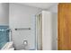 View of the bathroom highlighting a shower stall, toilet, and blue tile accents at 333 E Waterbury Rd, Indianapolis, IN 46227