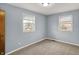 Empty bedroom featuring two windows that let in lots of natural light and neutral carpet at 333 E Waterbury Rd, Indianapolis, IN 46227