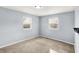 Cozy bedroom with neutral carpet, light blue walls and natural light from two windows creating a comfortable atmosphere at 333 E Waterbury Rd, Indianapolis, IN 46227