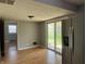 Bright dining area featuring hardwood floors, sliding glass doors to the backyard, and modern lighting at 333 E Waterbury Rd, Indianapolis, IN 46227