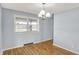 Dining room featuring wood floors, a window, and chandelier lighting at 333 E Waterbury Rd, Indianapolis, IN 46227