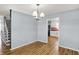 Bright dining room featuring wood floors and traditional chandelier lighting at 333 E Waterbury Rd, Indianapolis, IN 46227