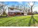 Attractive exterior view with a lush green lawn and mature trees, offering curb appeal at 333 E Waterbury Rd, Indianapolis, IN 46227