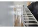 Hallway with wood floor and white staircase at 333 E Waterbury Rd, Indianapolis, IN 46227
