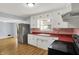 Bright kitchen features white cabinets and stainless steel refrigerator at 333 E Waterbury Rd, Indianapolis, IN 46227