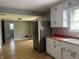 An eat-in kitchen featuring white cabinets, stainless steel refrigerator, and light pink backsplash at 333 E Waterbury Rd, Indianapolis, IN 46227