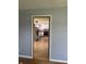 Framed view into the kitchen, showcasing white cabinets, stainless steel appliances, and wood-look floors at 333 E Waterbury Rd, Indianapolis, IN 46227