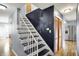 View of the staircase with dark blue accents leading to an upstairs hallway at 333 E Waterbury Rd, Indianapolis, IN 46227