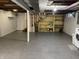 Unfinished basement area with painted floors and open ceiling featuring a washer and dryer hookup at 3516 Circle Blvd, Indianapolis, IN 46220