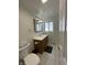 Well-lit bathroom with a wood vanity, white counter, and modern fixtures; features a window for natural light at 3516 Circle Blvd, Indianapolis, IN 46220