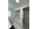 Bathroom with a soaking tub with tiled surround, a glass-enclosed shower, and a window for natural light at 3516 Circle Blvd, Indianapolis, IN 46220