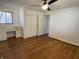 Bright bedroom featuring hardwood floors, a ceiling fan, and a built-in vanity with generous storage at 3516 Circle Blvd, Indianapolis, IN 46220
