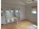 Bedroom featuring hardwood floors, natural light, a mirrored wall, and modern track lighting at 3516 Circle Blvd, Indianapolis, IN 46220