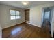 Bedroom featuring hardwood floors, white walls, and a built-in wooden wardrobe with drawers at 3516 Circle Blvd, Indianapolis, IN 46220