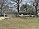 Charming single-story home with stone facade, attached garage, and mature trees at 3516 Circle Blvd, Indianapolis, IN 46220