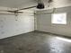 Clean garage featuring white walls, an automatic door, and a side window at 3516 Circle Blvd, Indianapolis, IN 46220