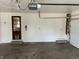 Spacious garage interior featuring a door to the interior and ladder to the attic at 3516 Circle Blvd, Indianapolis, IN 46220