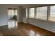 Bright living room featuring wood floors, multiple windows, and wainscotting at 3516 Circle Blvd, Indianapolis, IN 46220