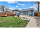Large backyard featuring a fire pit, seating, and detached garage, perfect for outdoor entertaining at 3535 Birchwood Ave, Indianapolis, IN 46205