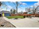 Spacious backyard with stone fire pit, patio with seating, and a detached garage at 3535 Birchwood Ave, Indianapolis, IN 46205