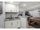 Basement bar area with light granite countertop and white cabinets at 3535 Birchwood Ave, Indianapolis, IN 46205