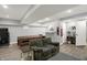 Finished basement featuring wood-look floors, a cozy seating area, and a table perfect for entertaining at 3535 Birchwood Ave, Indianapolis, IN 46205