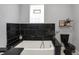 Elegant bathroom featuring a soaking tub, black accents, and a modern vanity at 3535 Birchwood Ave, Indianapolis, IN 46205