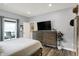 Bright bedroom featuring modern furniture, a large bed, and access to an outdoor patio at 3535 Birchwood Ave, Indianapolis, IN 46205