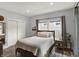 Cozy bedroom featuring hardwood floors, a comfortable bed, and bright natural light at 3535 Birchwood Ave, Indianapolis, IN 46205