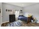 Cozy bedroom with wood floors, a bed with navy bedding, and a chest of drawers at 3535 Birchwood Ave, Indianapolis, IN 46205