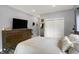Spacious bedroom with a wooden dresser, large closet, and comfortable king size bed at 3535 Birchwood Ave, Indianapolis, IN 46205