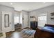 This bedroom features wood-look floors, a desk, and natural light at 3535 Birchwood Ave, Indianapolis, IN 46205