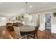 Open-concept dining area with hardwood floors and a round wooden table, seamlessly connected to the living space at 3535 Birchwood Ave, Indianapolis, IN 46205