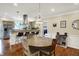Dining area with a round table and chairs, adjacent to a kitchen with a breakfast bar and stainless steel appliances at 3535 Birchwood Ave, Indianapolis, IN 46205