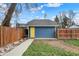 A single car garage with a yellow door sits at the back of the home at 3535 Birchwood Ave, Indianapolis, IN 46205