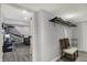 Hallway leading to a finished basement featuring a recreational area with seating and a sports game at 3535 Birchwood Ave, Indianapolis, IN 46205