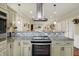 Modern kitchen with granite countertops, stainless steel appliances, and a view into the dining and living areas at 3535 Birchwood Ave, Indianapolis, IN 46205