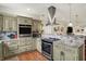 Gourmet kitchen with stainless steel appliances, granite countertops, and custom cabinetry at 3535 Birchwood Ave, Indianapolis, IN 46205