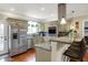 Updated kitchen with stainless steel appliances, granite countertops, breakfast bar, and stylish pendant lighting at 3535 Birchwood Ave, Indianapolis, IN 46205