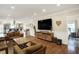Bright, open-concept living space with hardwood floors flowing into kitchen and bedroom at 3535 Birchwood Ave, Indianapolis, IN 46205