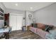 Living room with wood-look floors, a comfortable couch, and a desk area at 3535 Birchwood Ave, Indianapolis, IN 46205