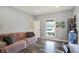 Bright living room with wood-look floors, a comfortable couch, and natural light at 3535 Birchwood Ave, Indianapolis, IN 46205