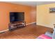 Spacious living area featuring hardwood floors, a modern television, and vibrant, contrasting wall colors at 3540 N Norfolk St, Indianapolis, IN 46224